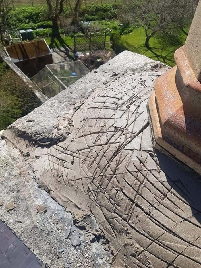 New cement applied to the base of a chimney